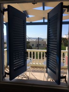 Looking out of the blue-painted shutters to the terrace...